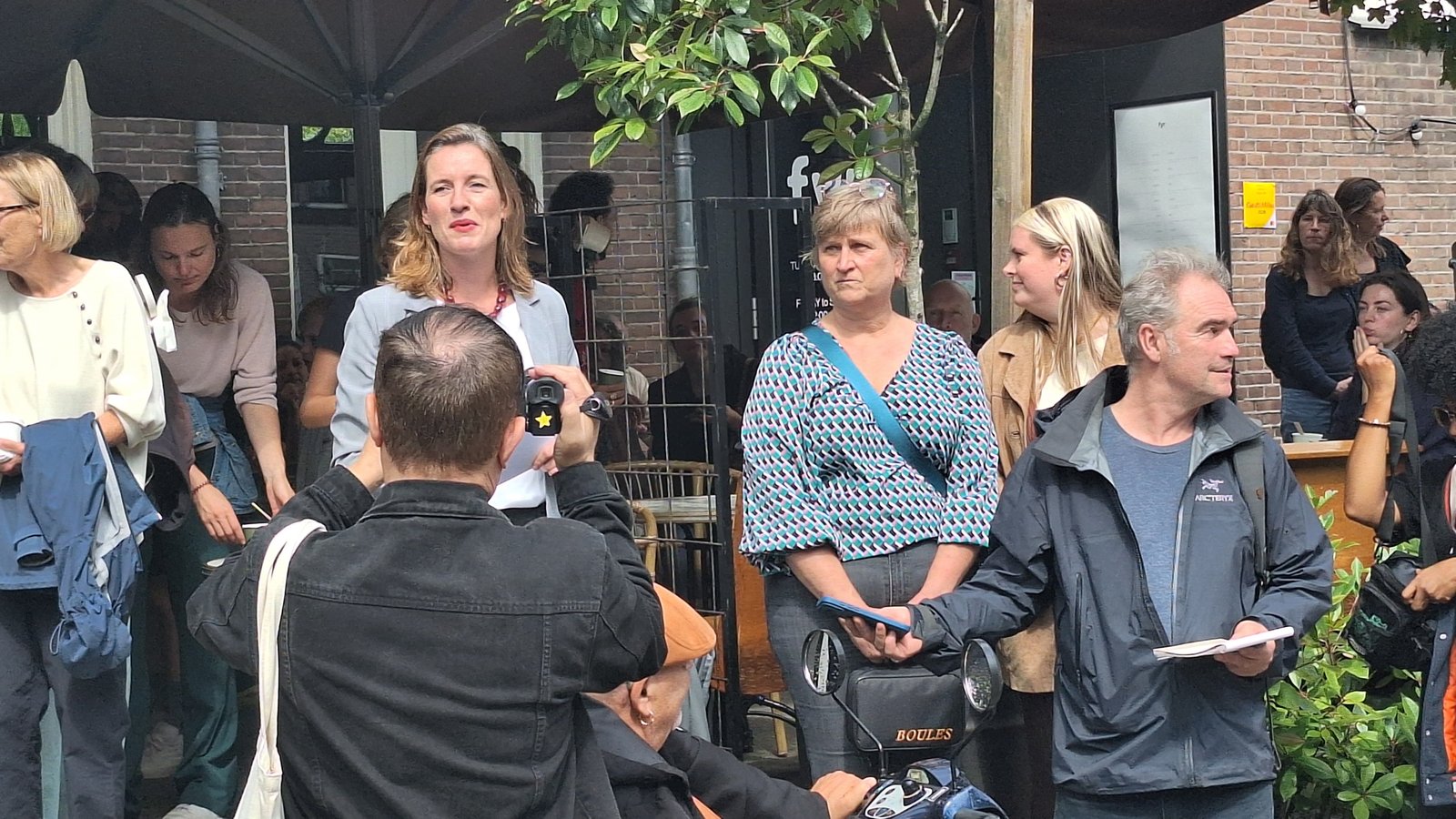Stadsdeelvoorzitter Amélie Strens tussen buurtbewoners en ondernemers bij de opening van de vernieuwde Czaar Peterstraat